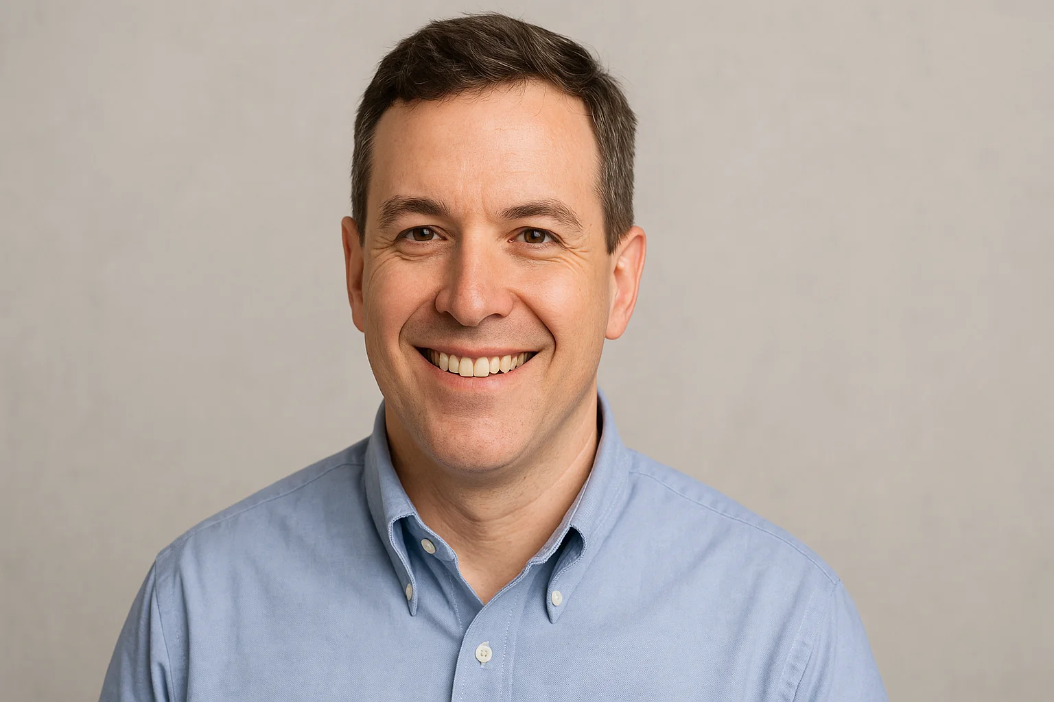 a smiling man in a blue shirt